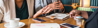 A group of people having a meeting and coffee